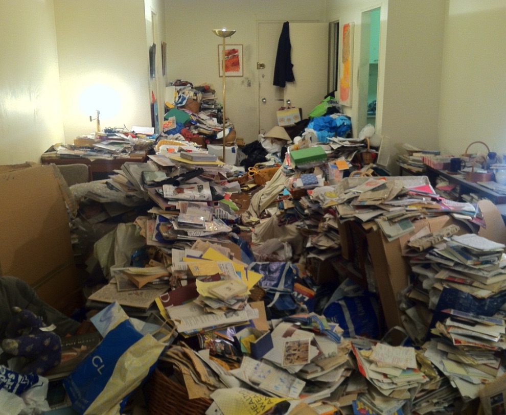 Berkley room with papers, bags, and blocked paths before careful hoarding cleanup